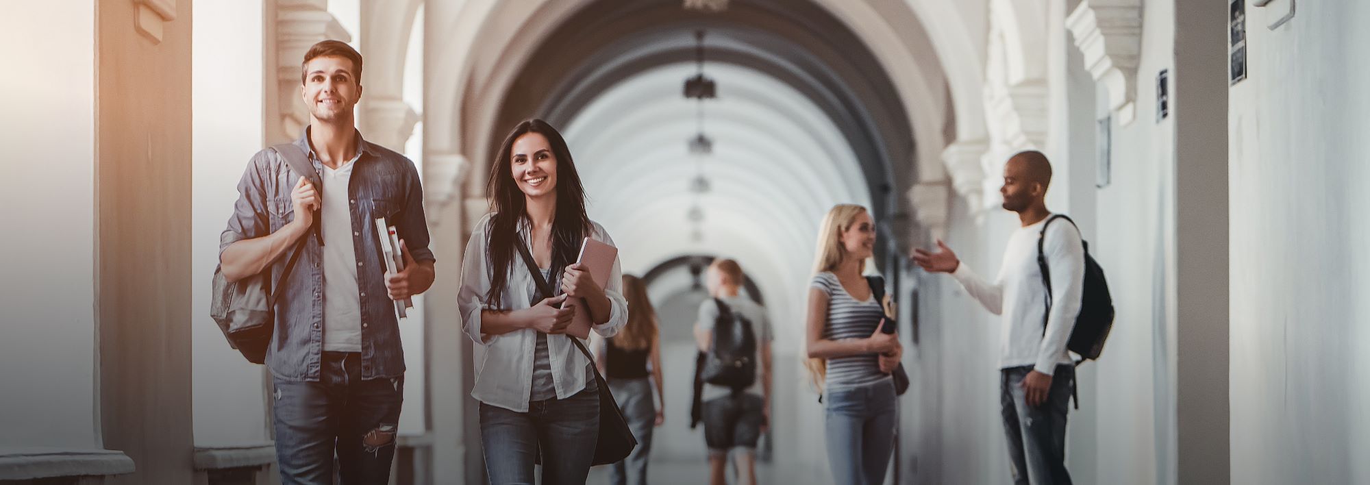 Image of college students carrying books