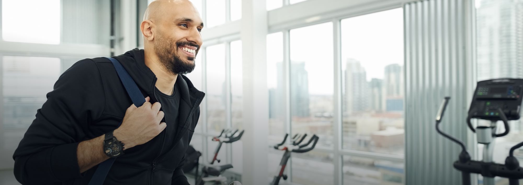 Image of person in gym carrying bag 