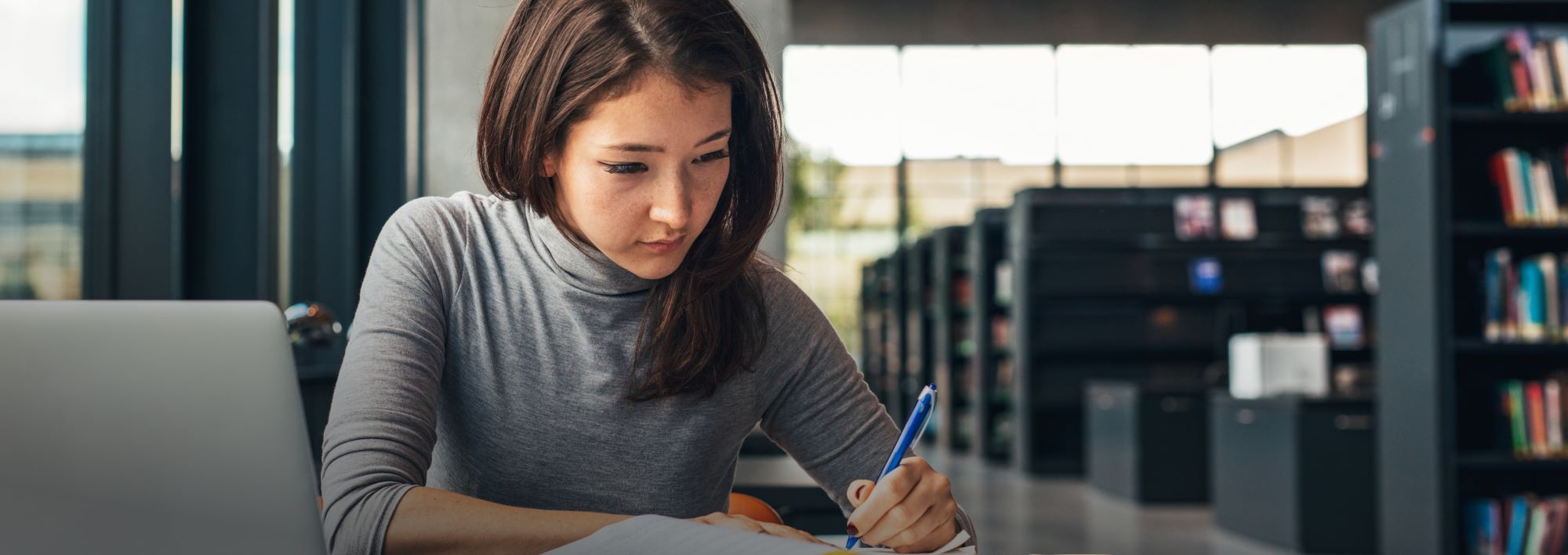 Image of person studying in a library 