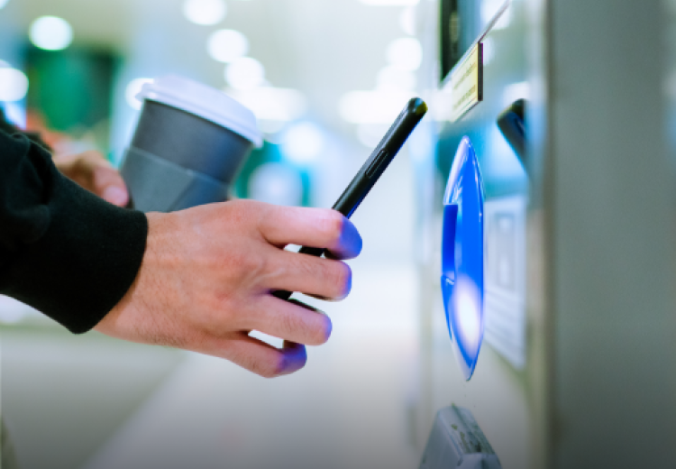 Picture of phone being used to pay at vending machine 